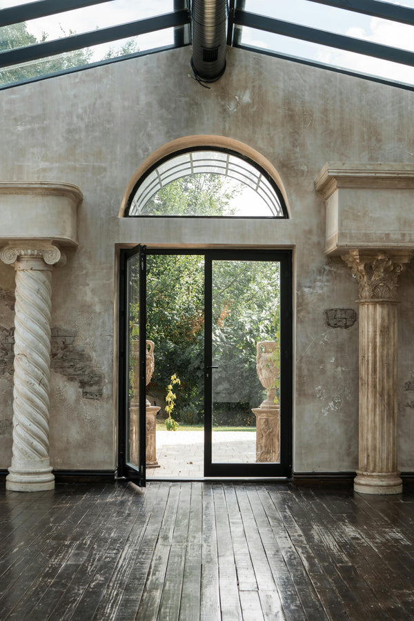 Modern double iron doors with full-height glass panels