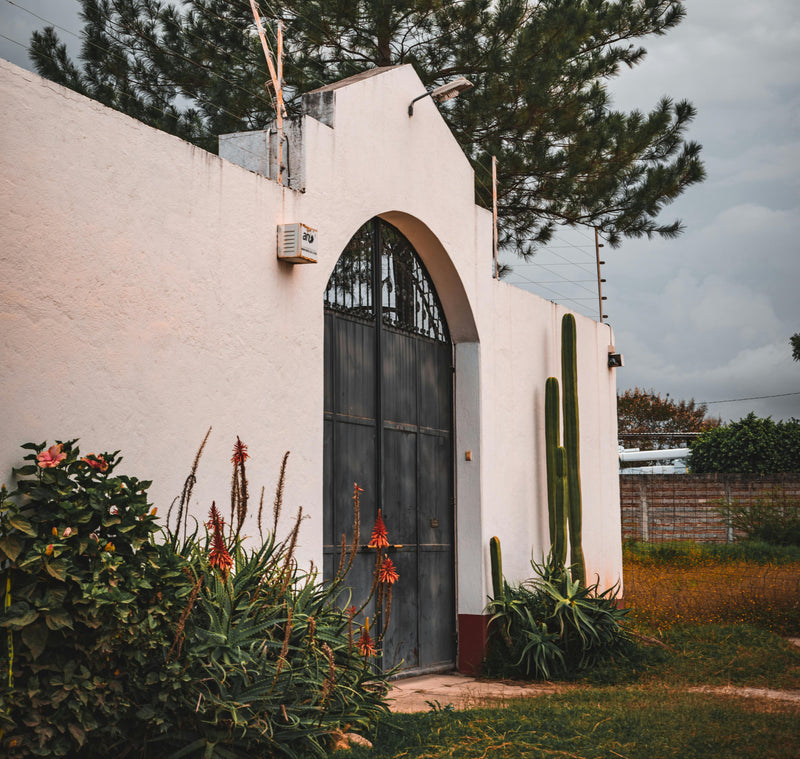Ornate wrought iron entry doors with decorative scroll pattern and glass panels