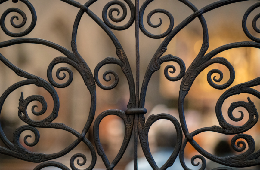 Handcrafted iron scrollwork for an iron entry door