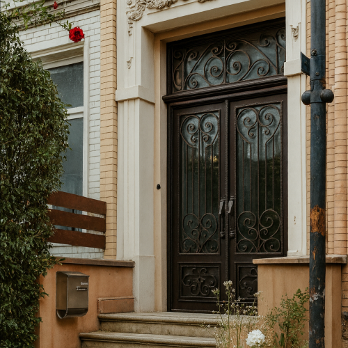 Traditional iron door with square top and ornate panel detail