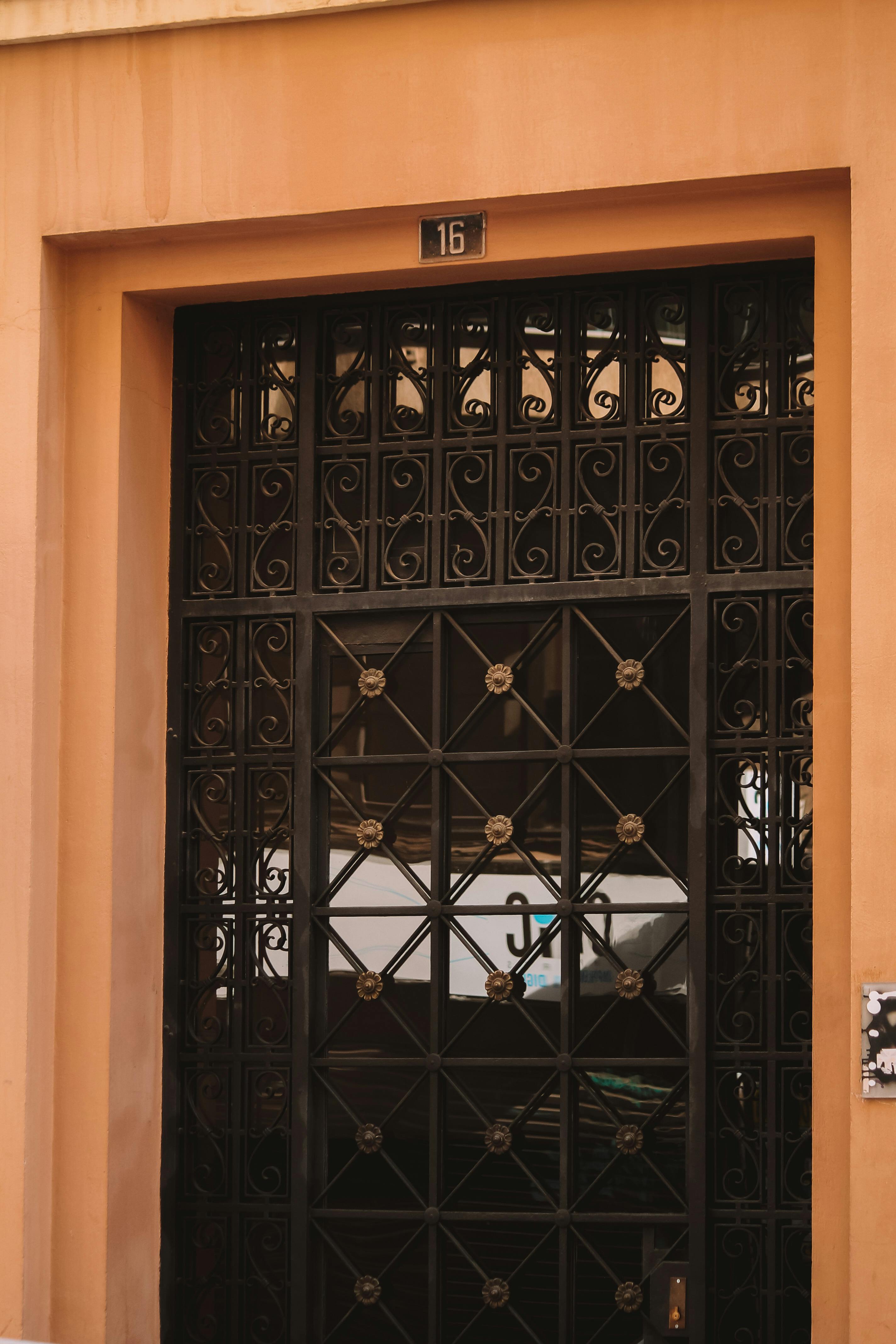 Hand-forged wrought iron scrollwork on entry door